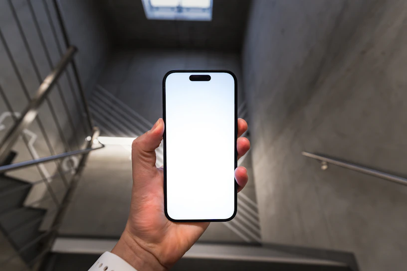 A person holding a cell phone in their hand
