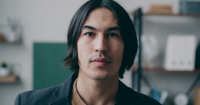 confident man with distinctive style in black jacket