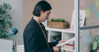 A man standing in front of a book shelf
