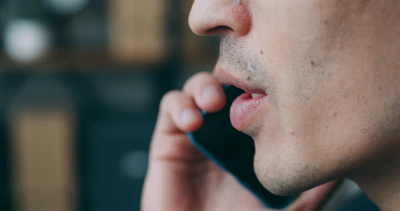 A close up of a person talking on a cell phone