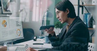 A woman sitting at a desk in front of a computer