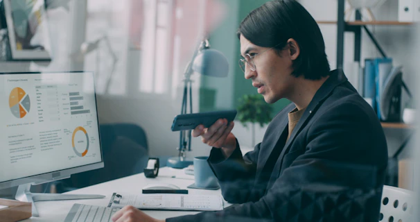 A woman sitting at a desk in front of a computer