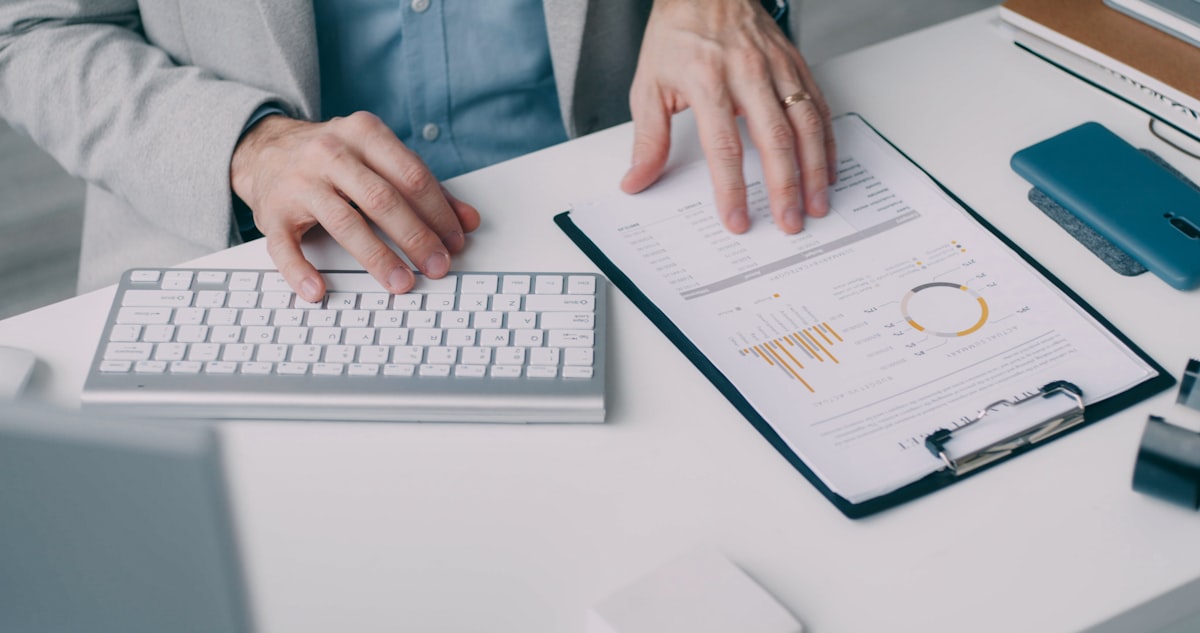 Accountant reviewing financial statements on a computer using AI analysis software in 2026