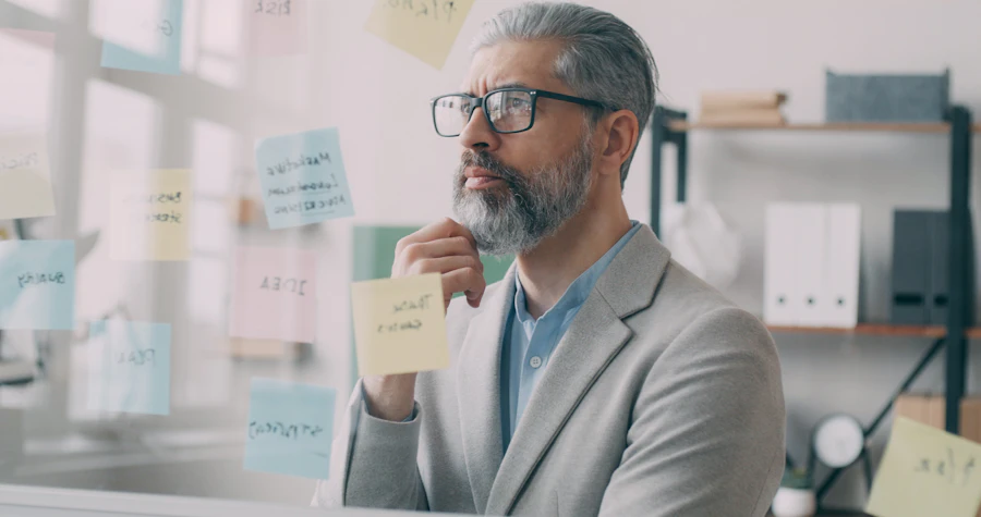 Professional in suit and glasses reviewing a document