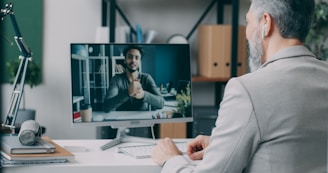 A man sitting at a desk in front of a computer