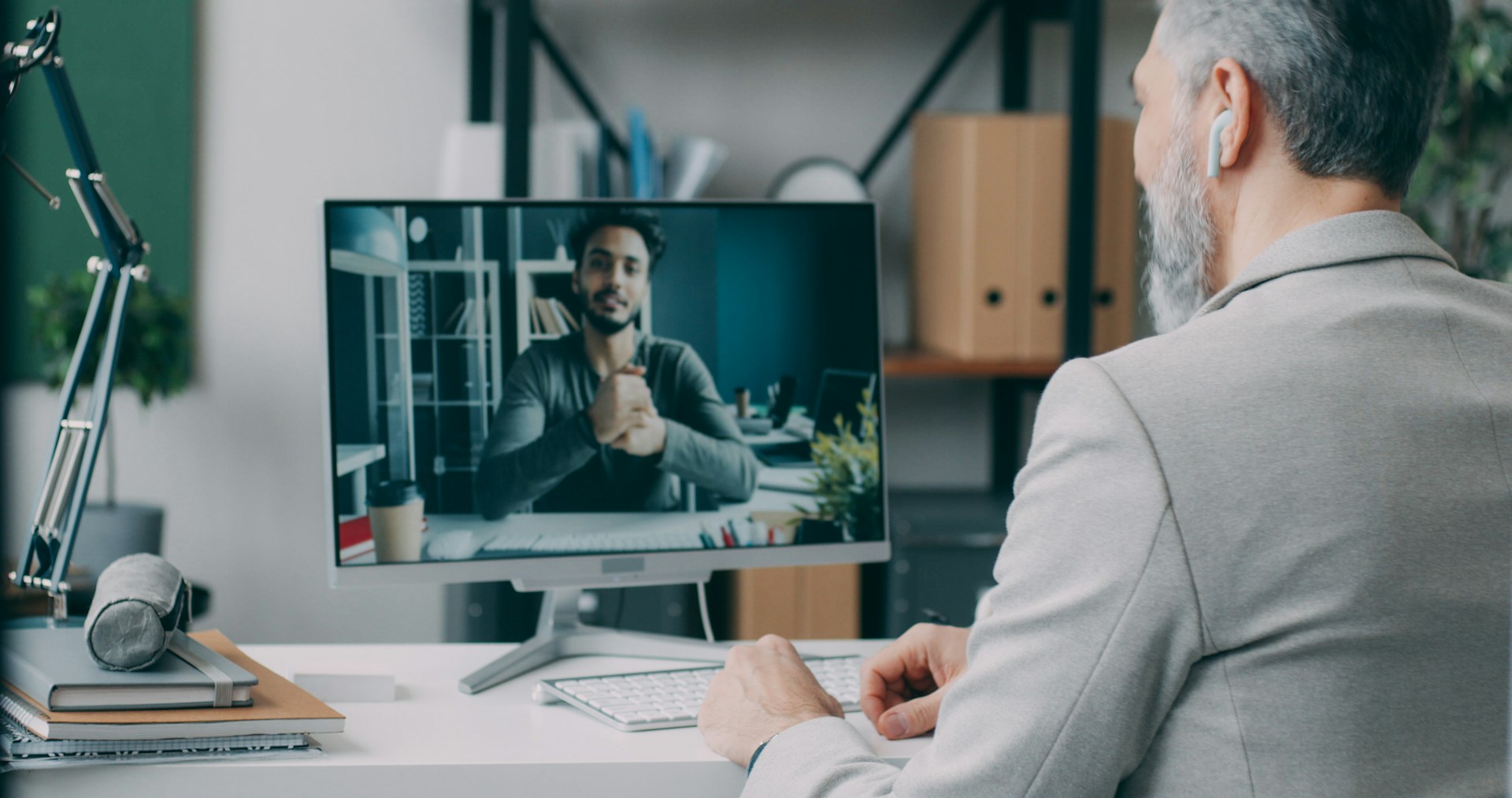 A man sitting at a desk in front of a computer