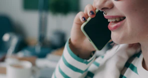 A woman talking on a cell phone with a smile on her face