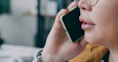A woman with glasses talking on a cell phone