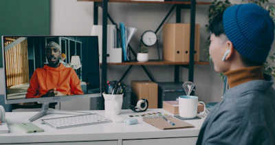 A person sitting at a desk with a computer