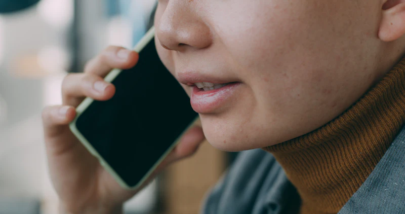 Person holding a phone to their ear during a call