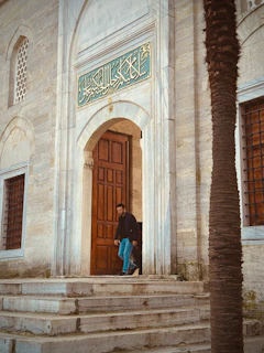 A man standing in a doorway of a building
