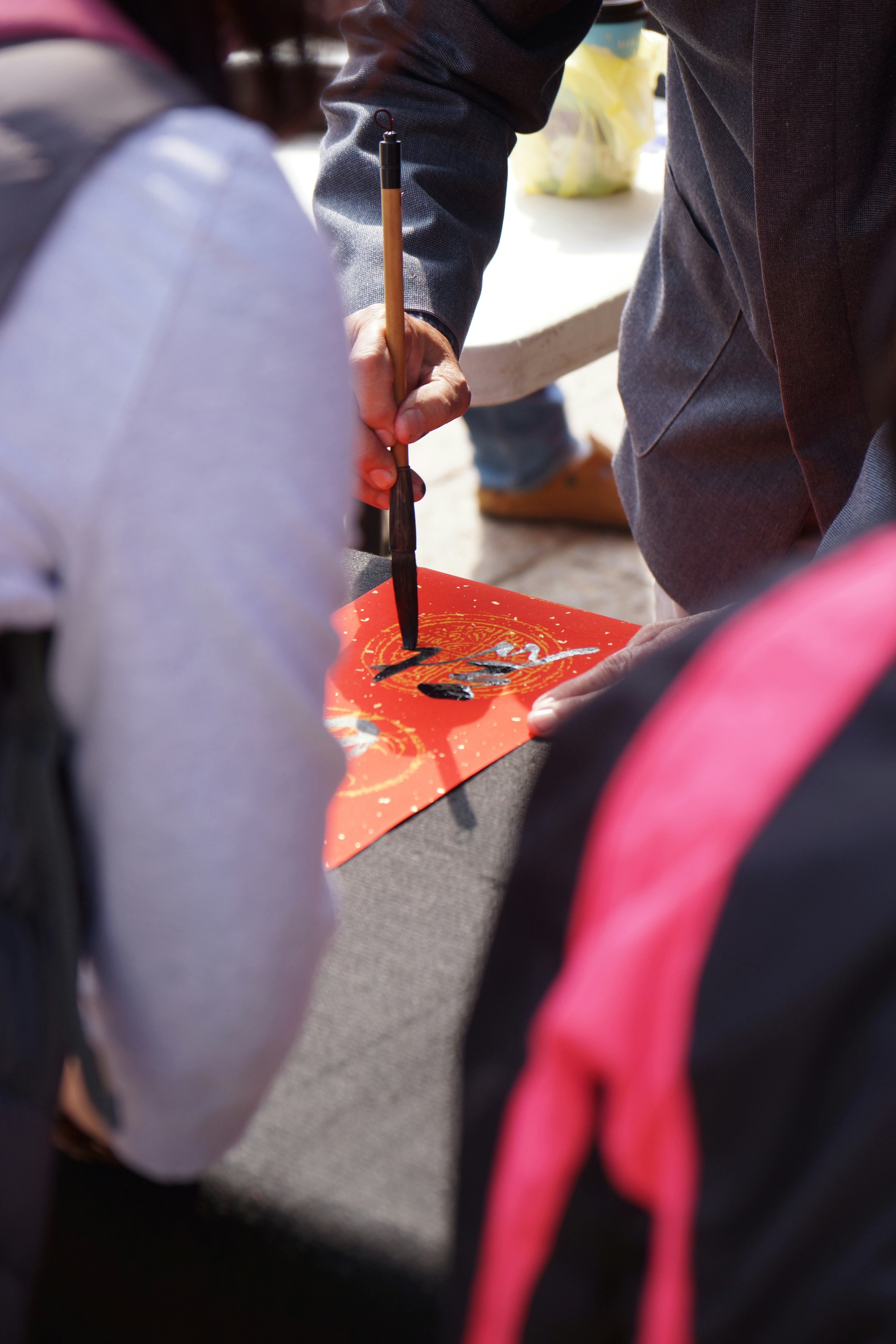 A group of people standing around a table with a knife