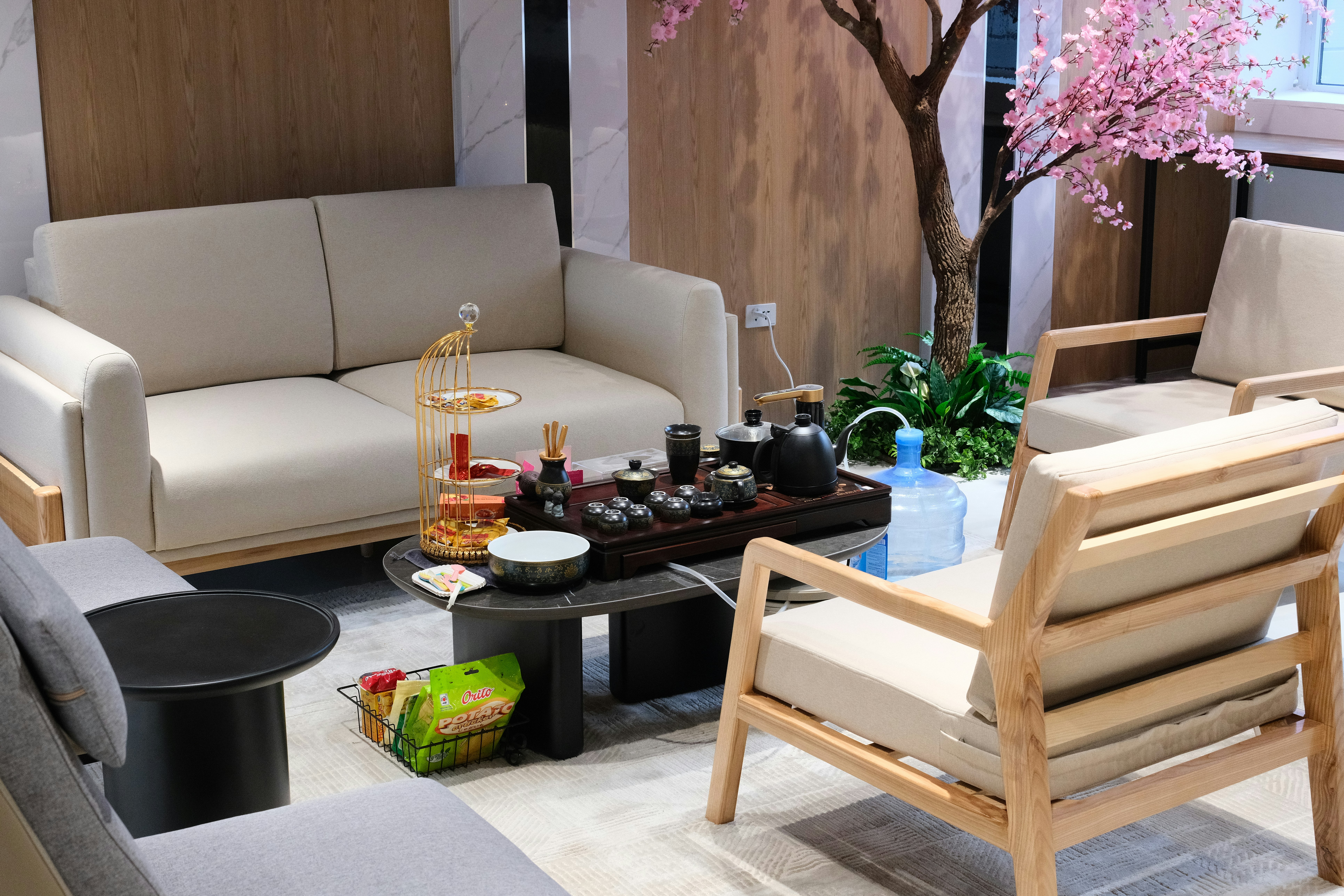 A living room filled with furniture and a tree
