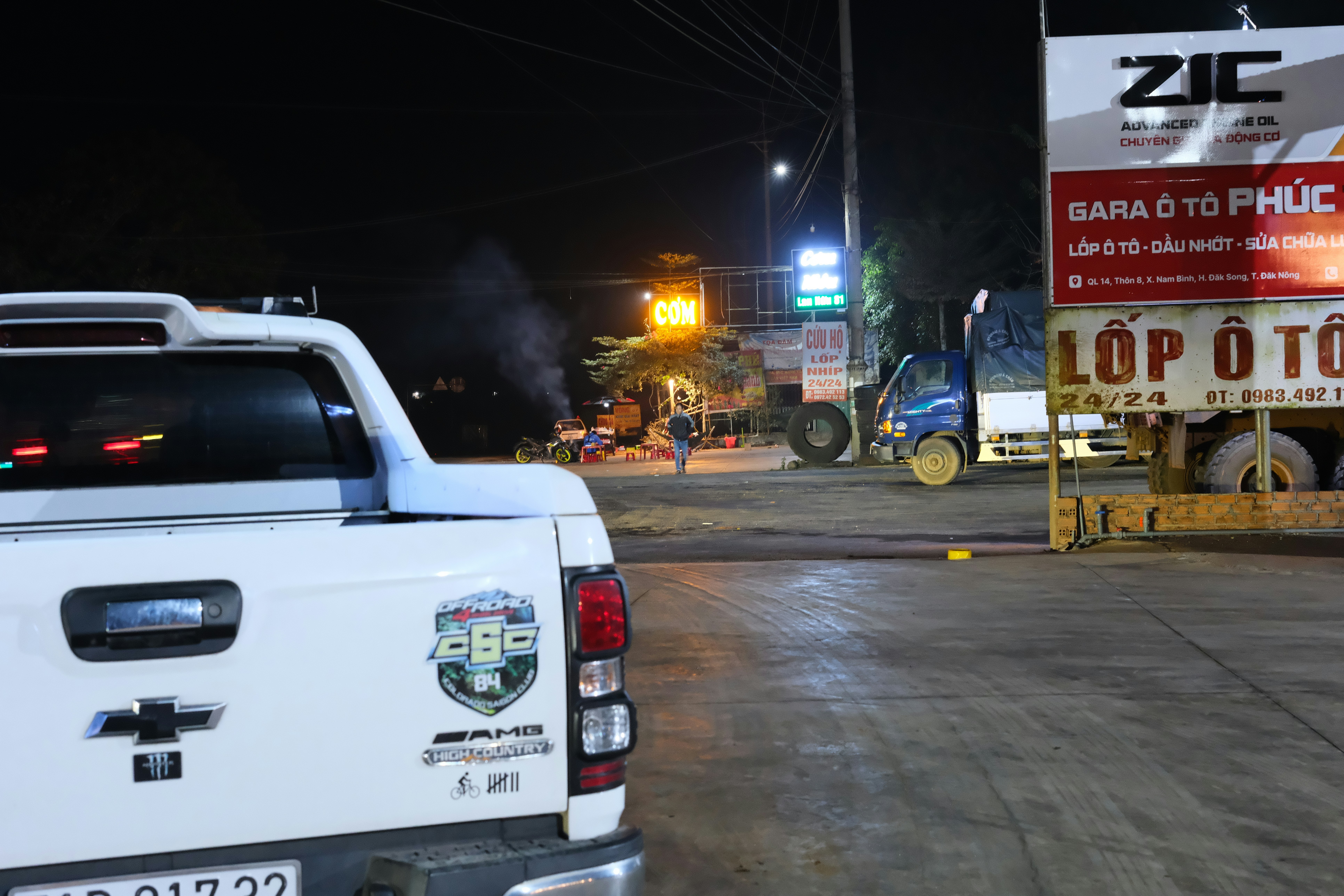 A white pick up truck parked in a parking lot