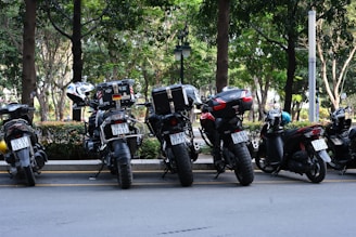 A row of motorcycles parked on the side of a road
