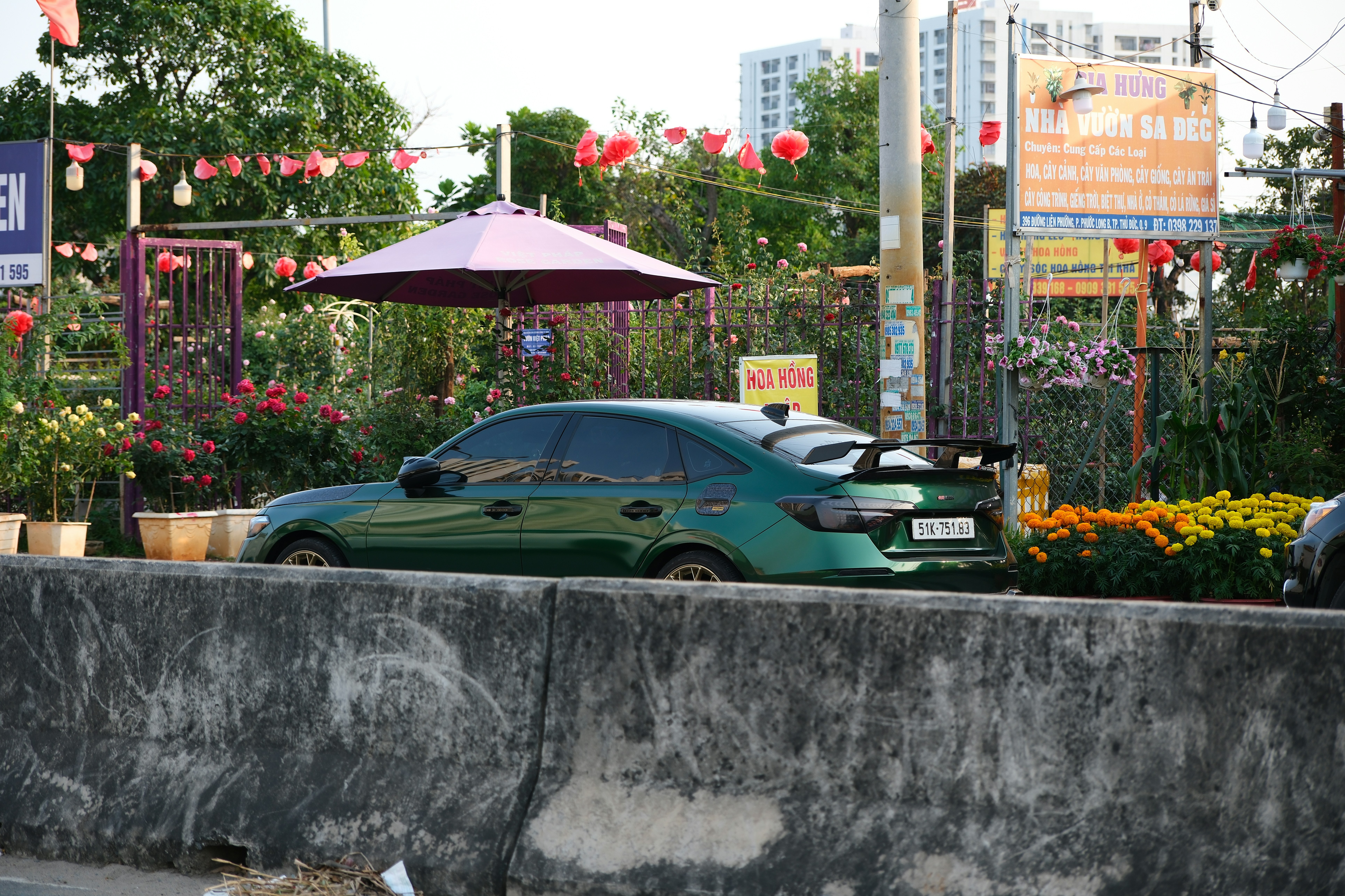 Small electric hatchback charging at a station in an urban parking garage