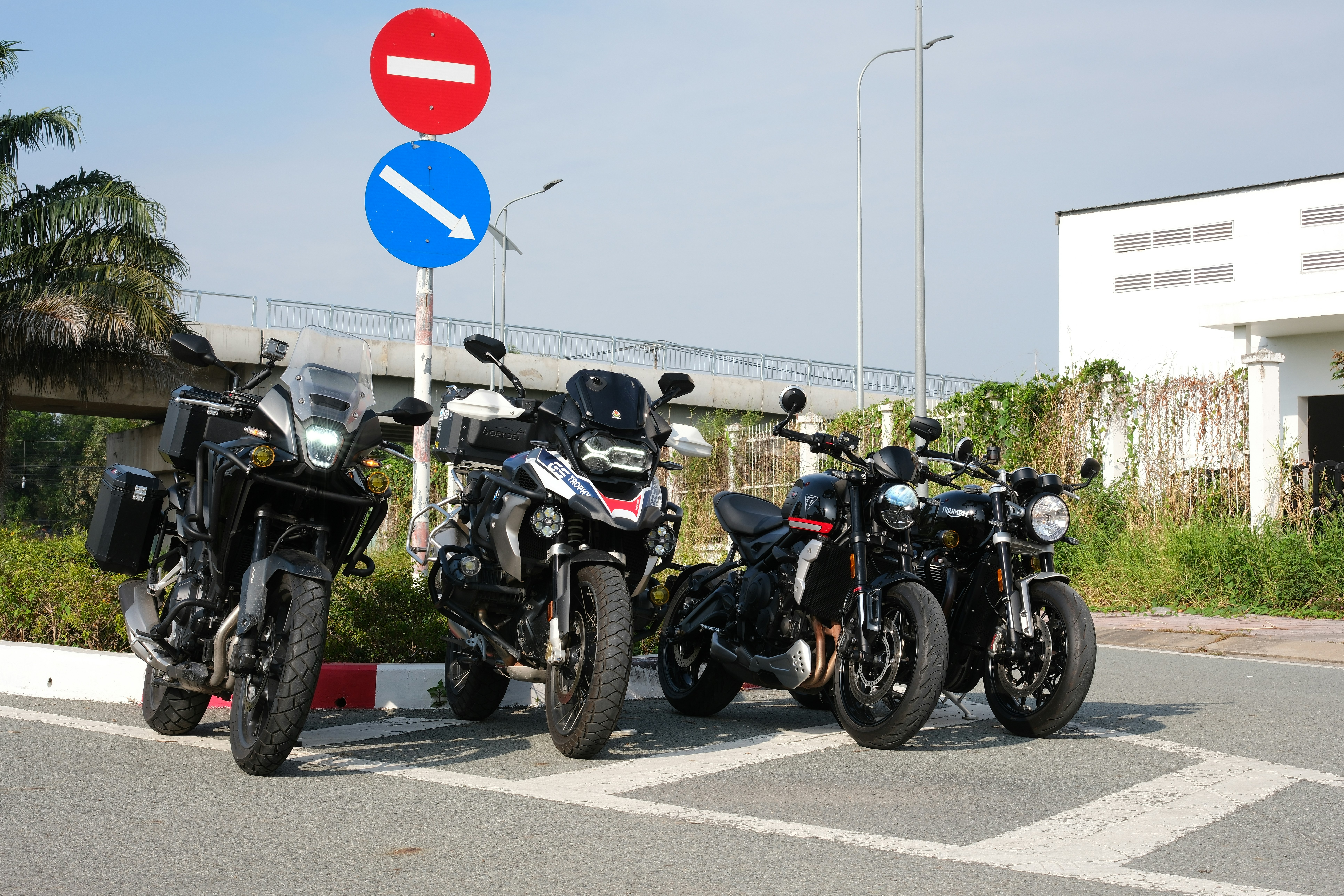 A group of motorcycles parked next to a street sign