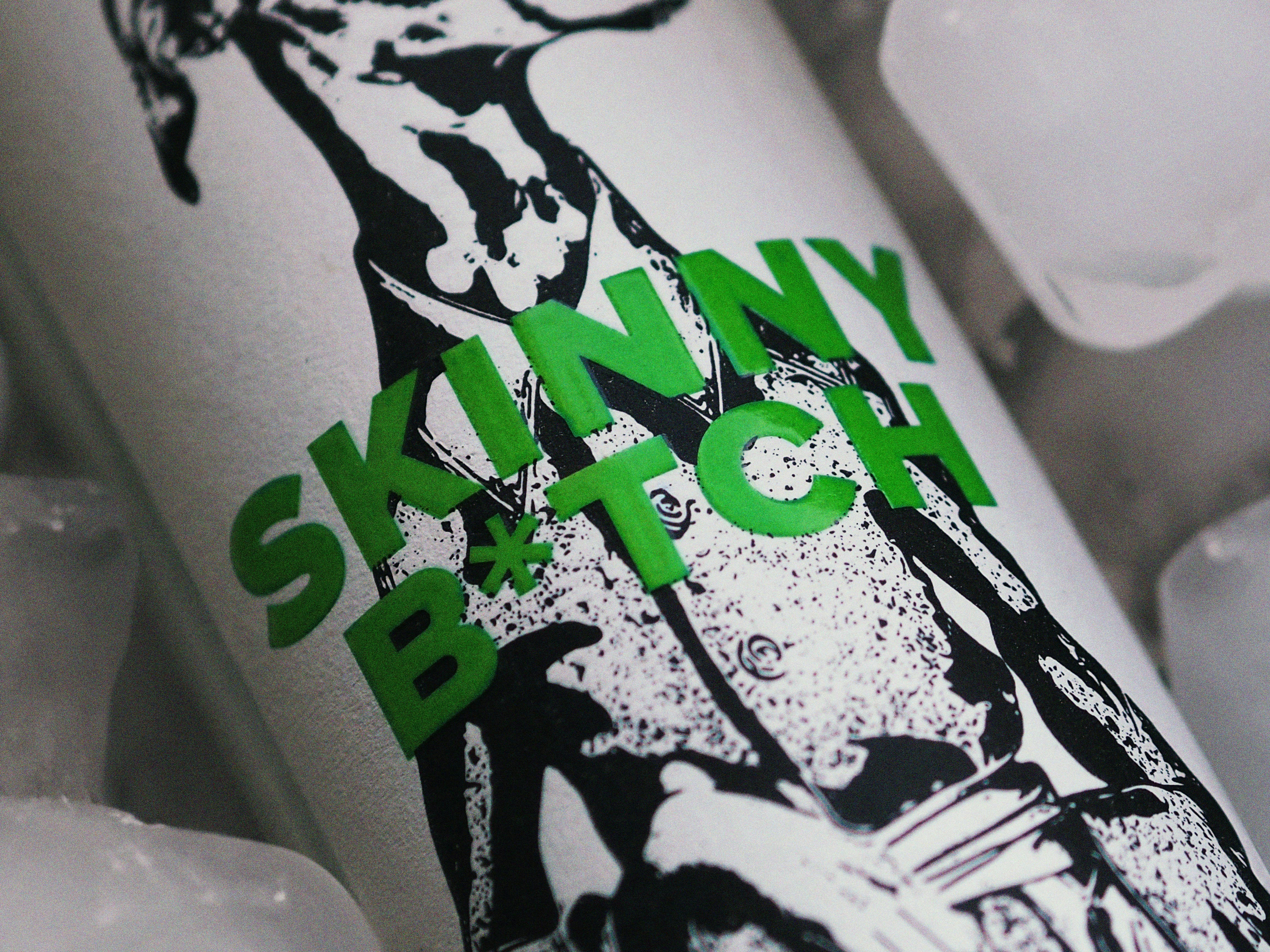 A bottle of skinny bitch sitting on top of ice