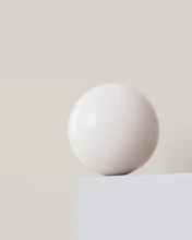 A white ball sitting on top of a white box