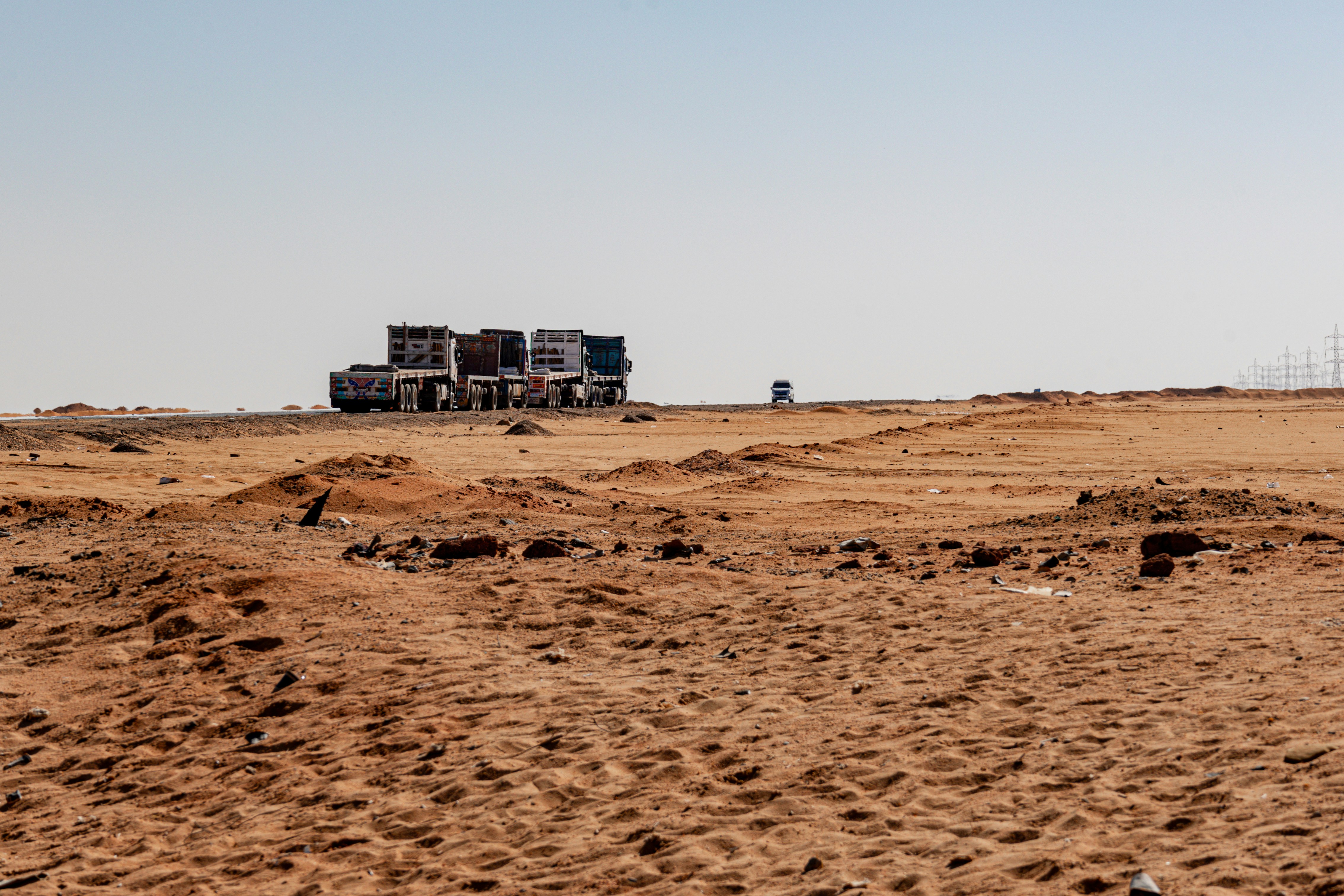A truck is parked in the middle of a dirt field