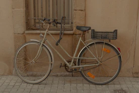 A bicycle parked on the side of a building