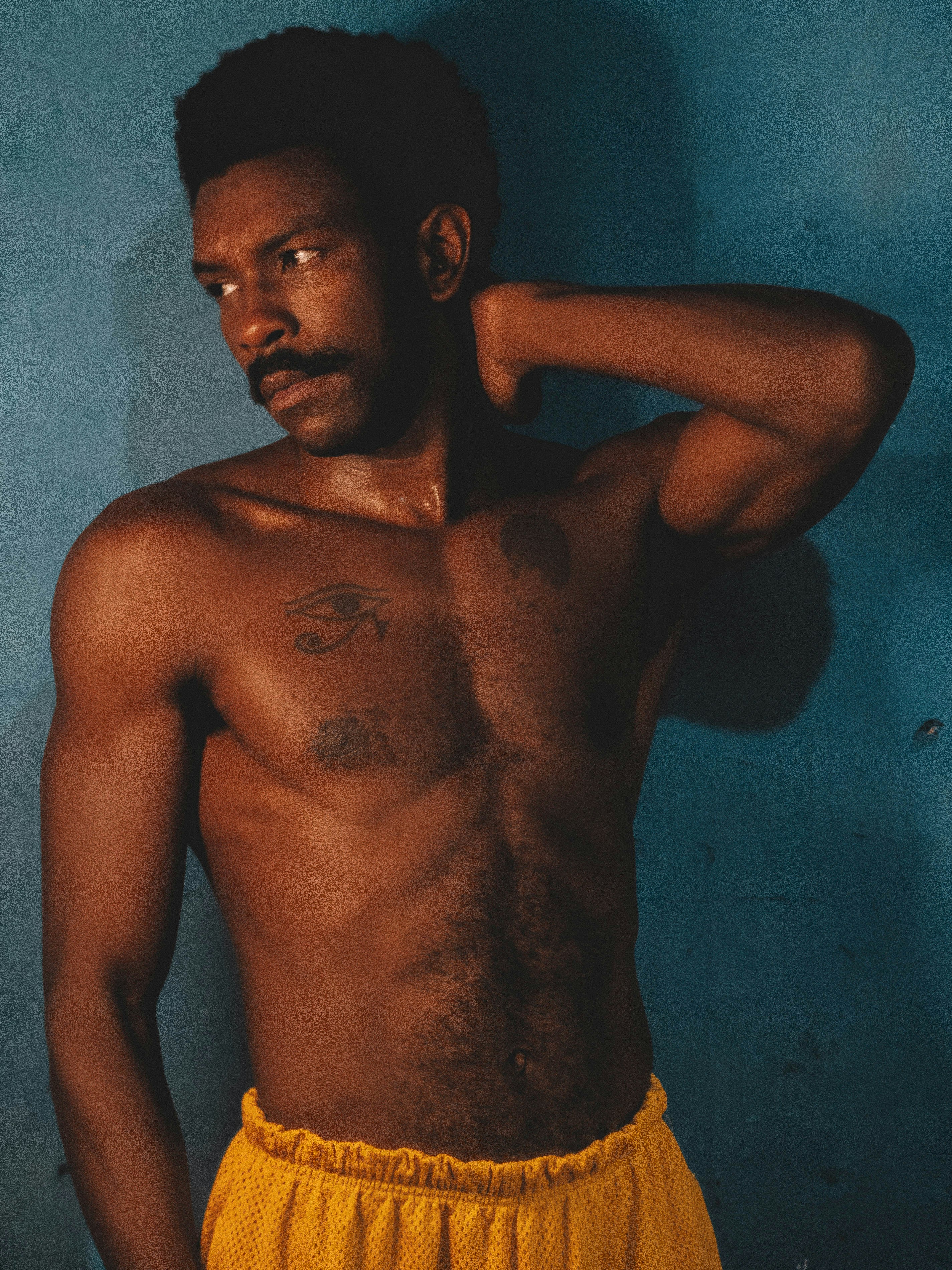 A man in a yellow shorts posing for a picture