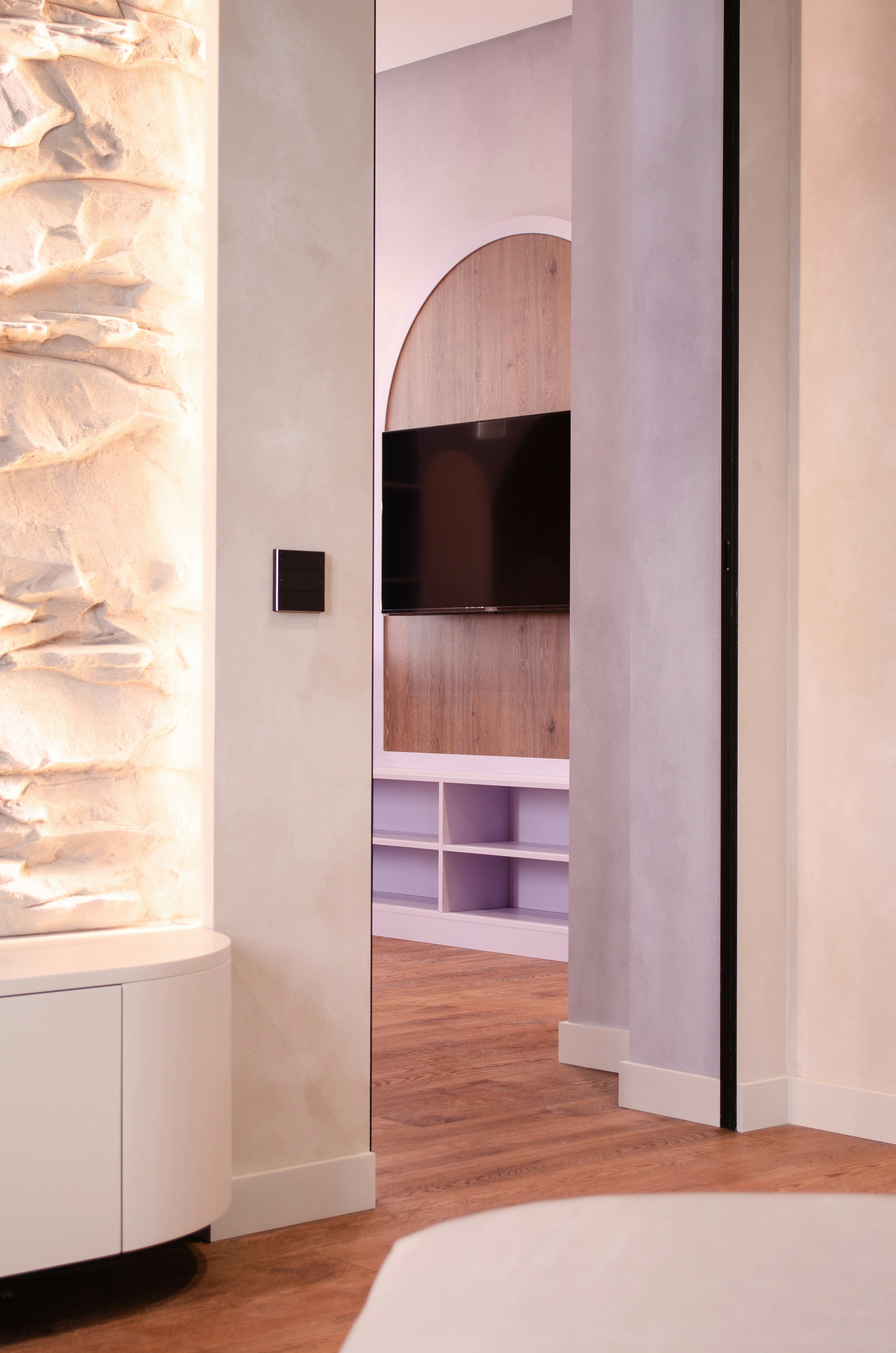 A living room with a white couch and a TV