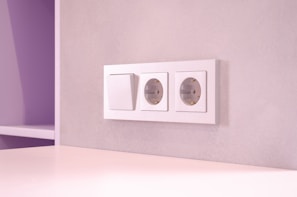 A room with a white table and a purple wall