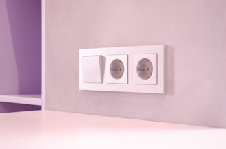 A room with a white table and a purple wall