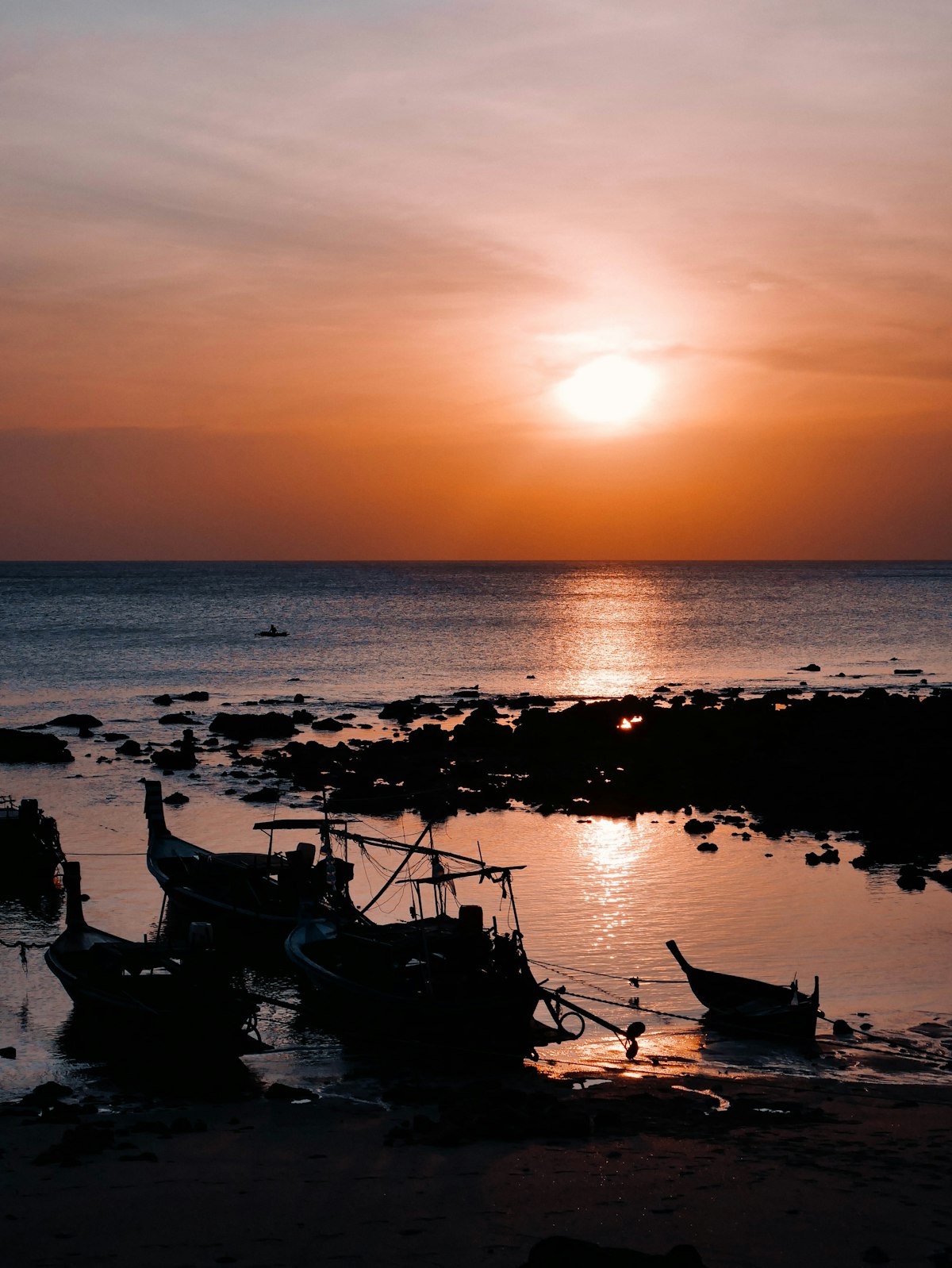 Long Beach Koh Lanta — longtail boats on golden sand at sunset with calm Andaman Sea