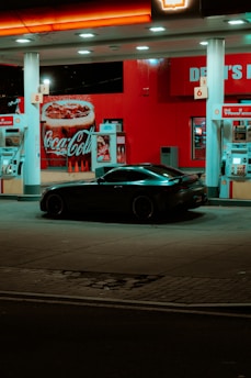 A car parked in front of a gas station