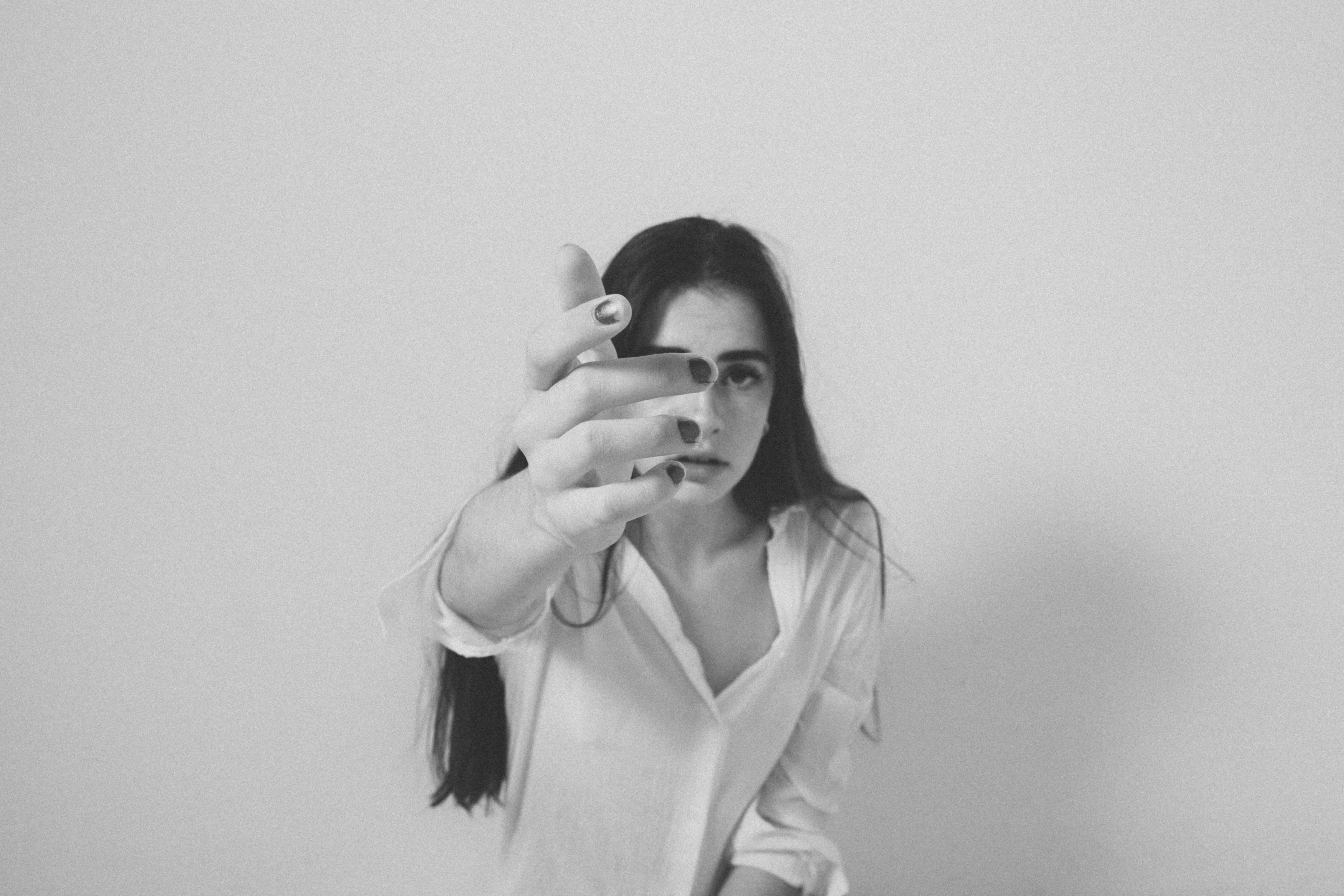 A black and white photo of a woman brushing her teeth