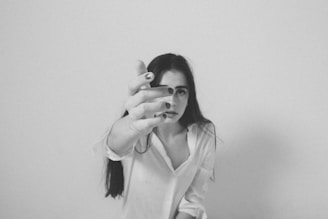A black and white photo of a woman brushing her teeth