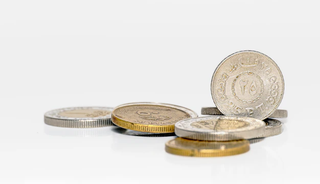 A pile of coins sitting on top of a white table