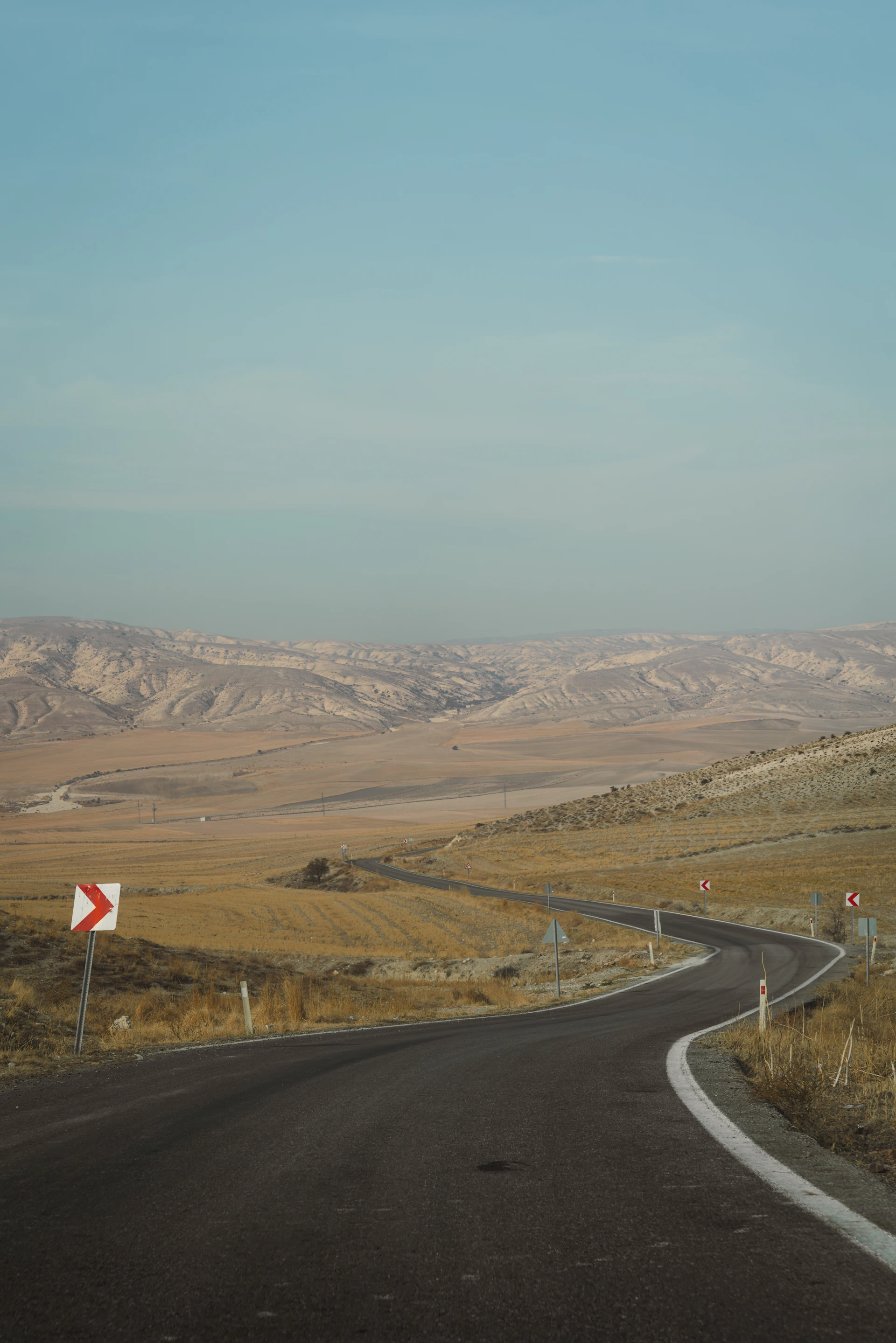 A winding road in the middle of the desert