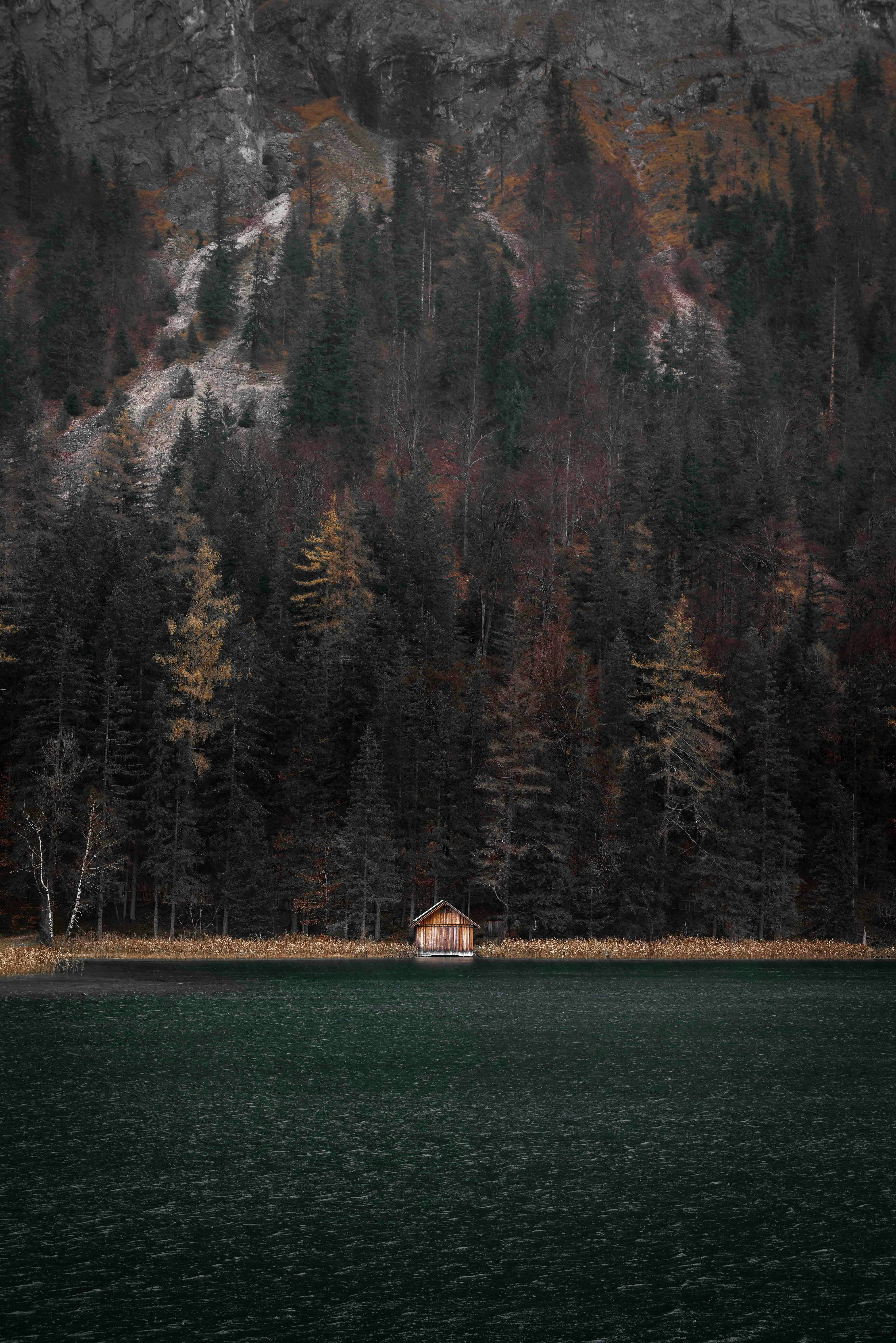 A house sitting on the edge of a body of water