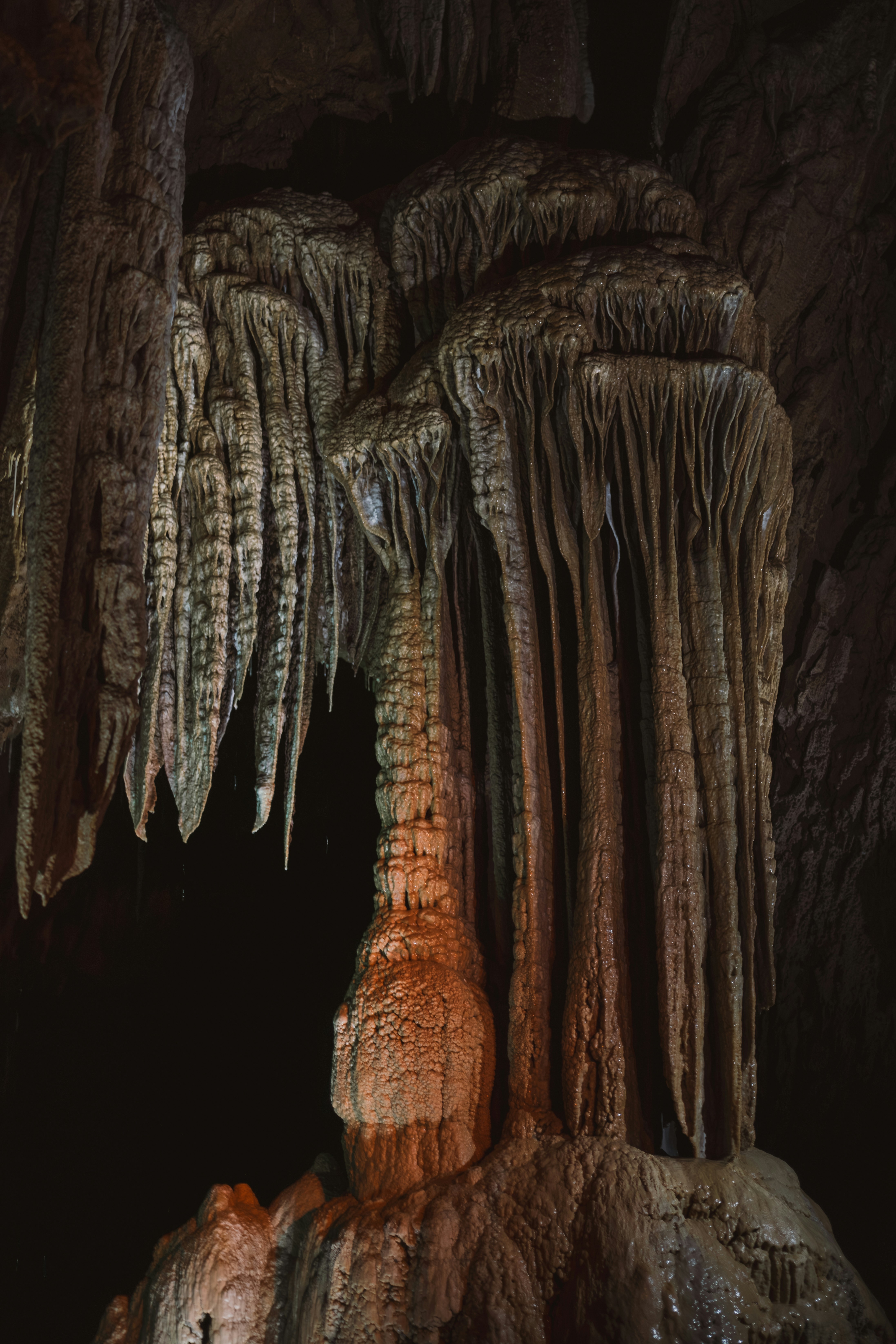 A group of people standing inside of a cave