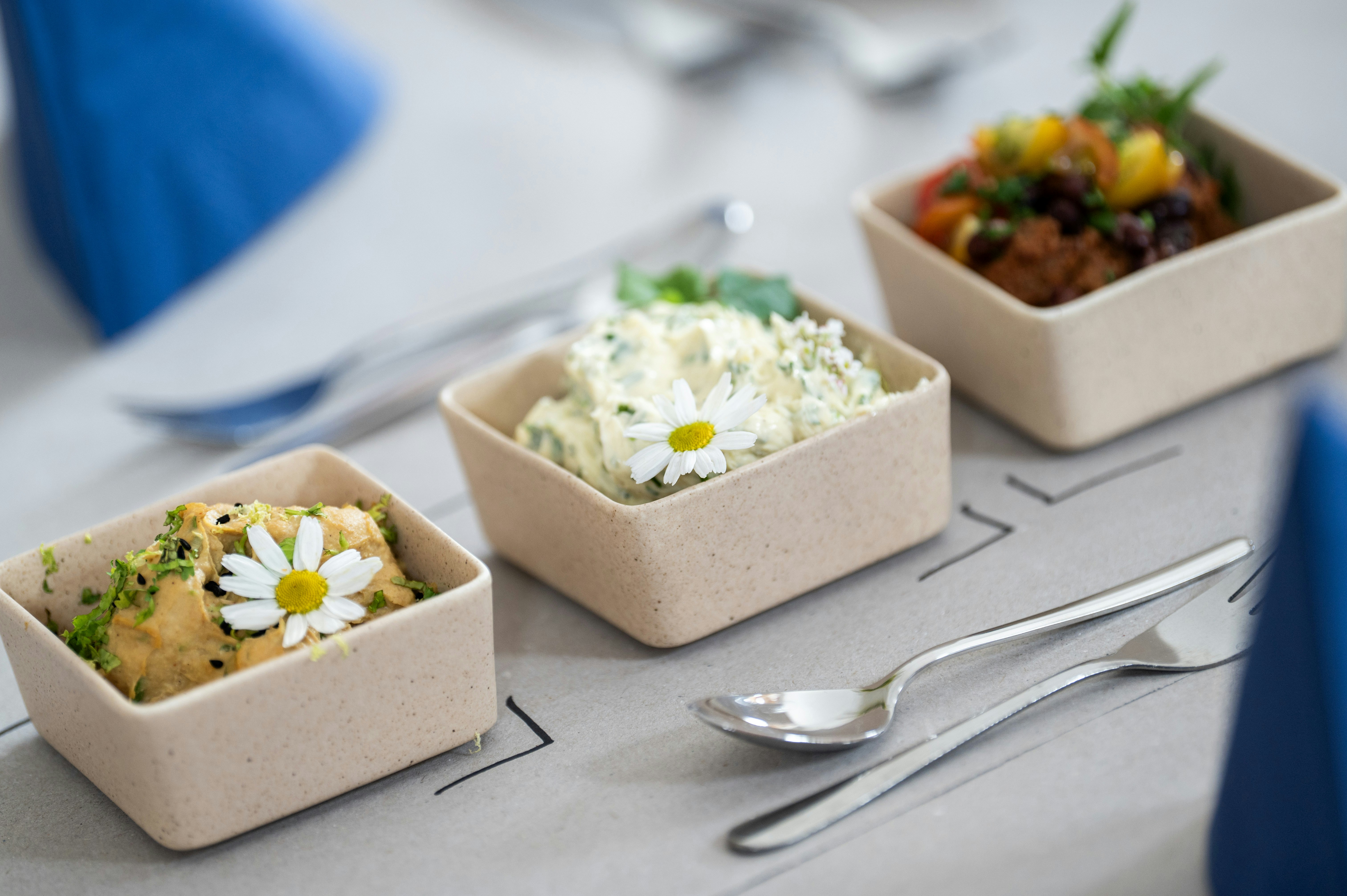 A table topped with three containers filled with food photo – Free ...