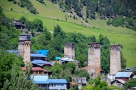 A view of a village with a mountain in the background