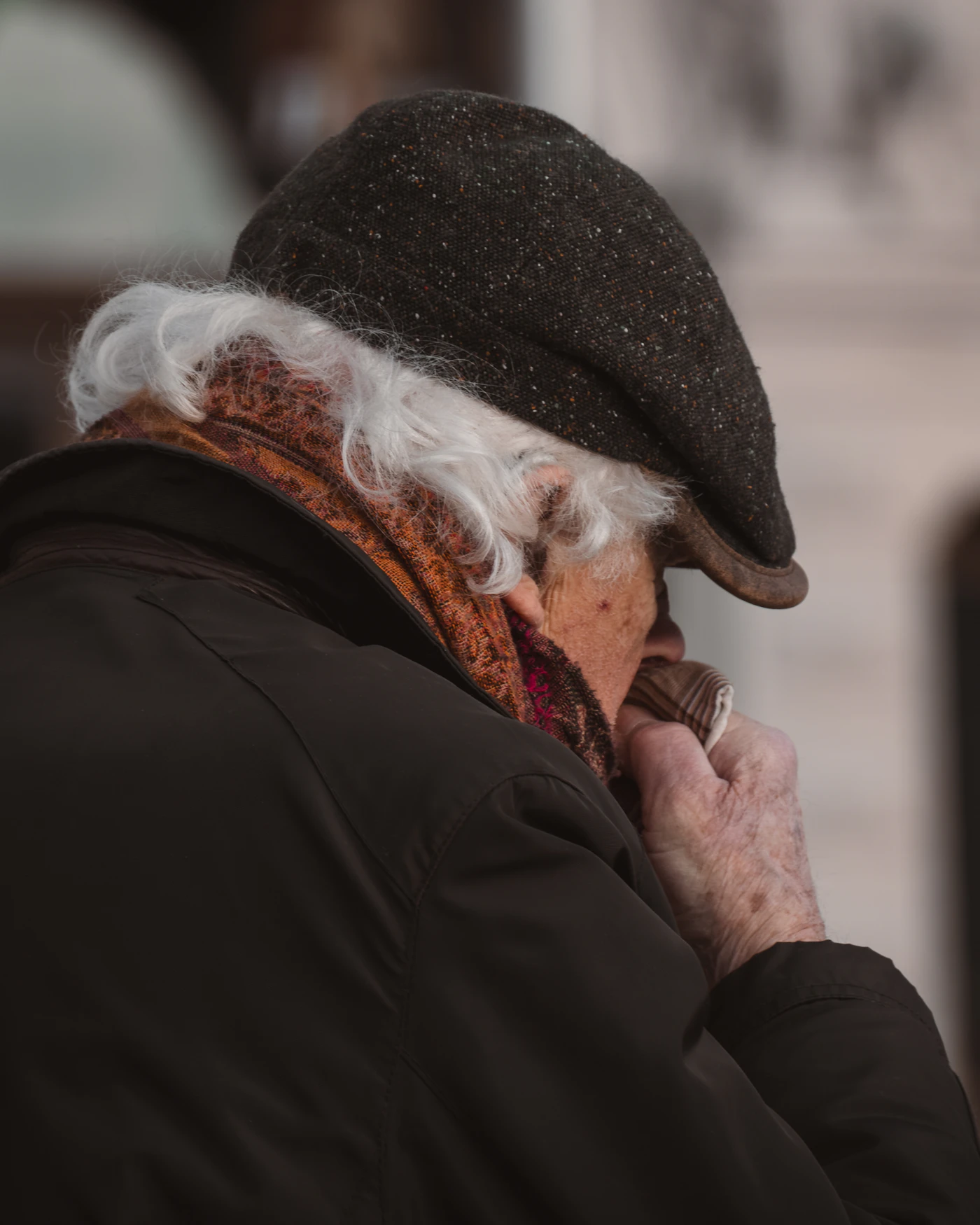 An older man on the phone, looking worried
