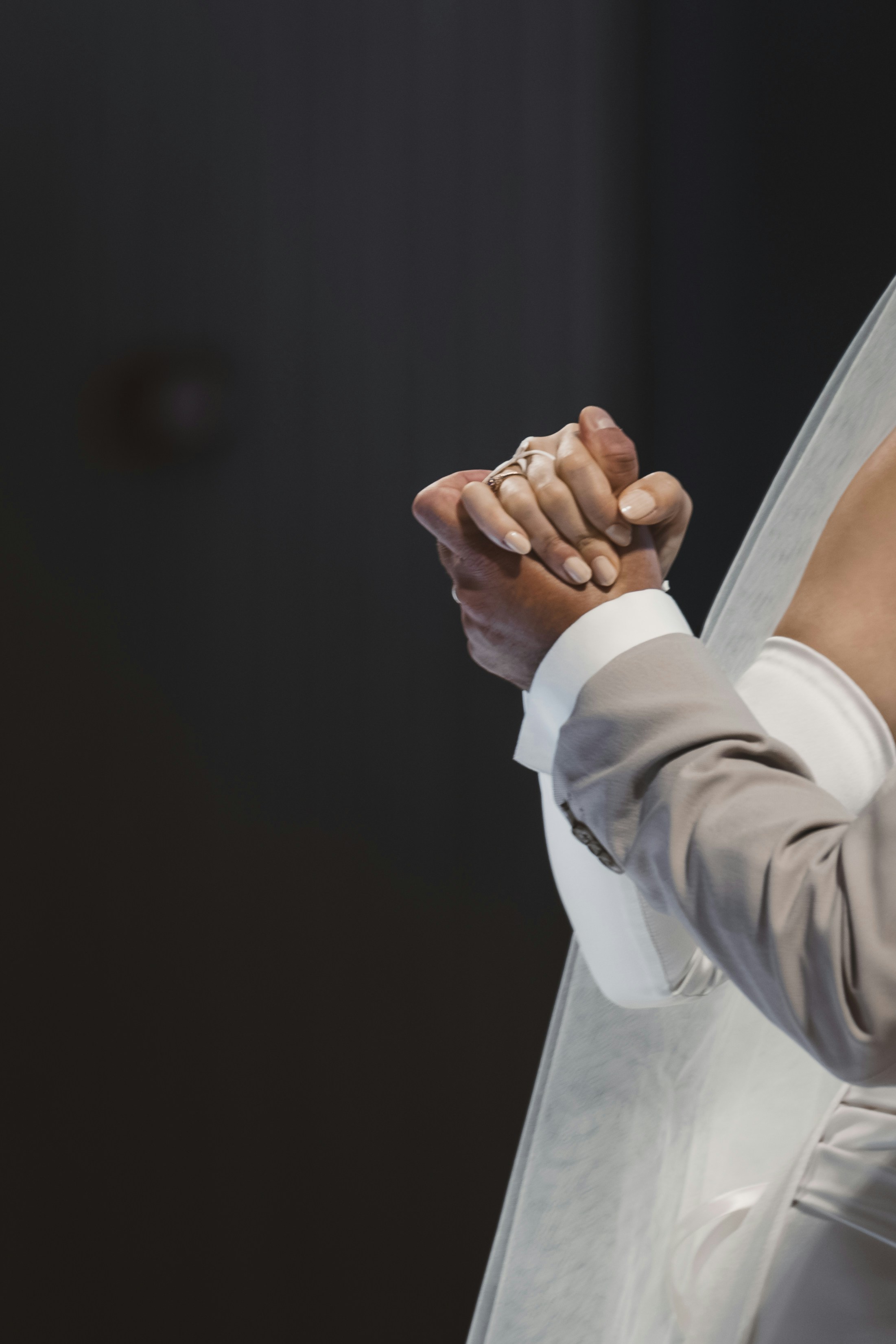 A woman in a wedding dress holding a veil