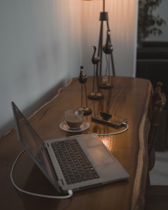 A laptop computer sitting on top of a wooden table