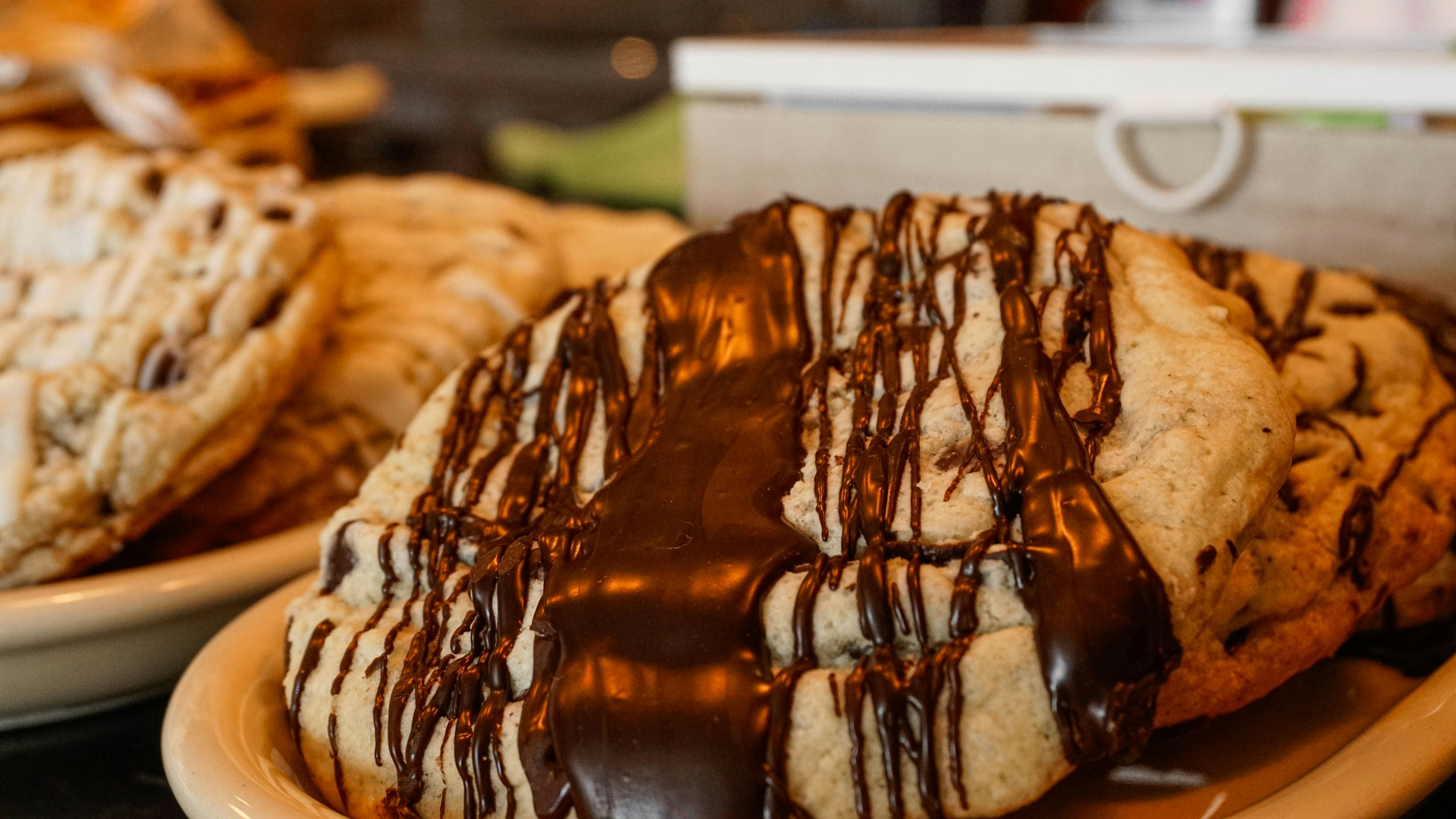 A close up of a plate of cookies covered in chocolate