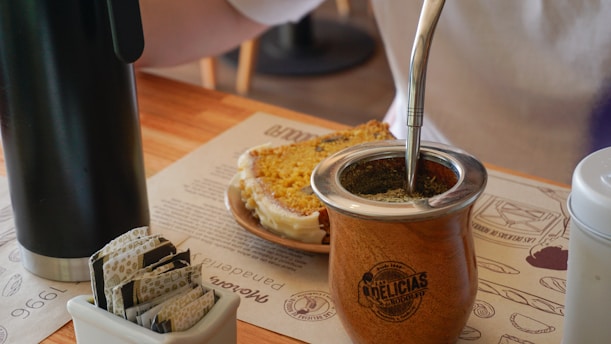 A person pouring something into a jar on a table