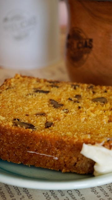 A piece of bread with butter on a plate