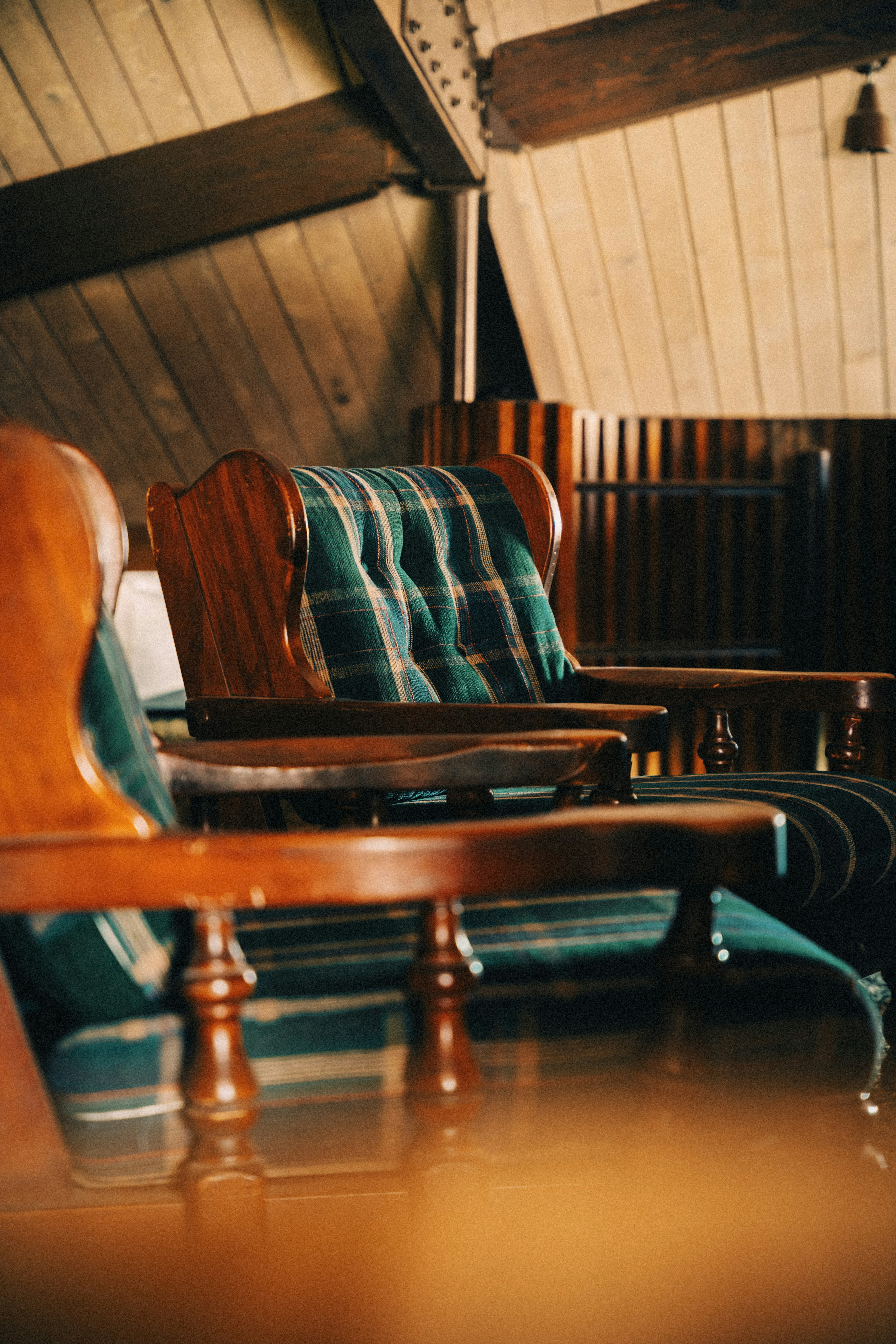 A row of wooden chairs sitting next to each other