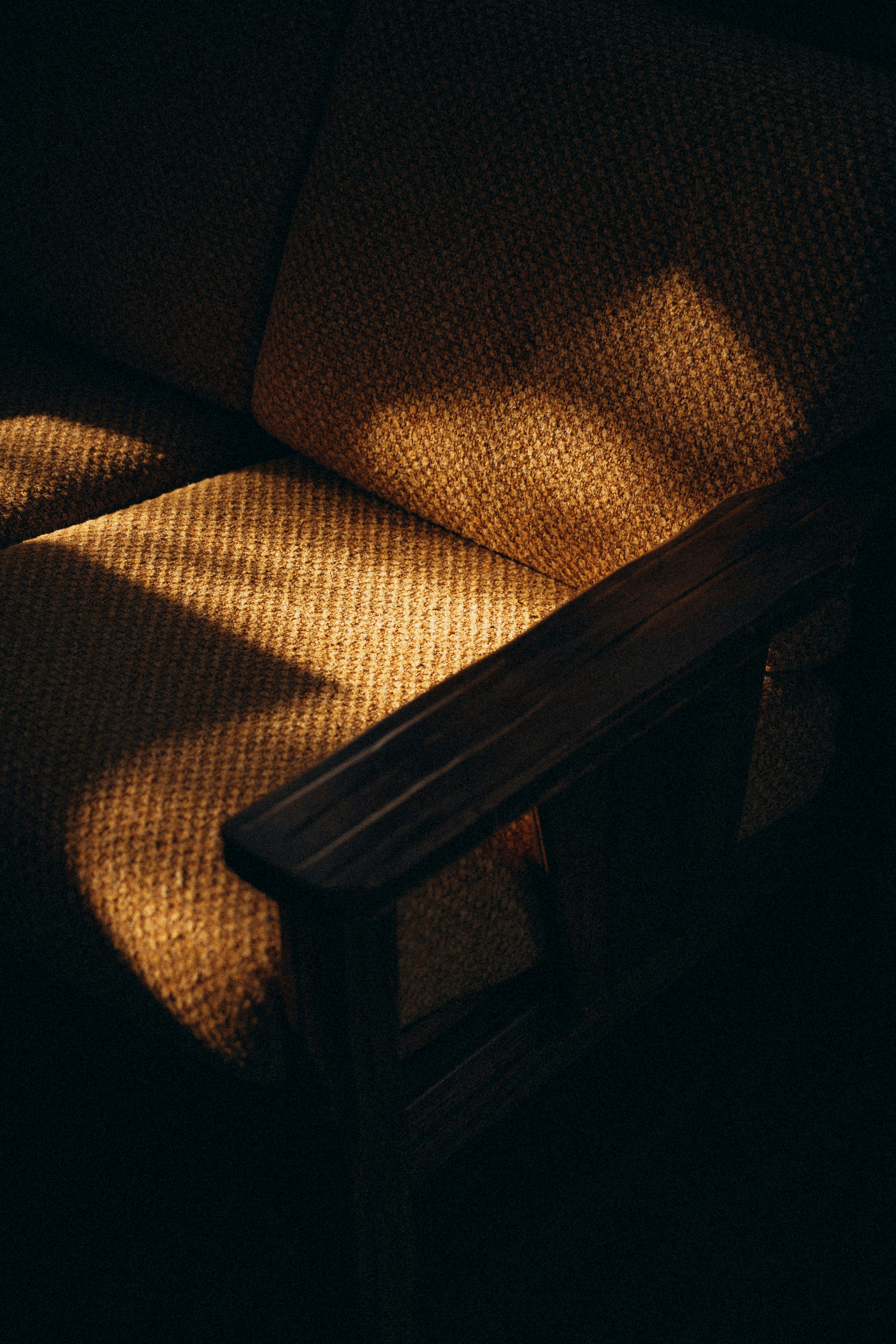 A wooden bench sitting in a dark room