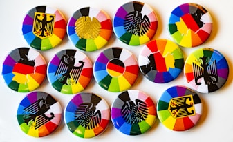 A white plate topped with lots of colorful buttons