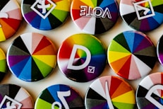 A bunch of different colored buttons on a white surface