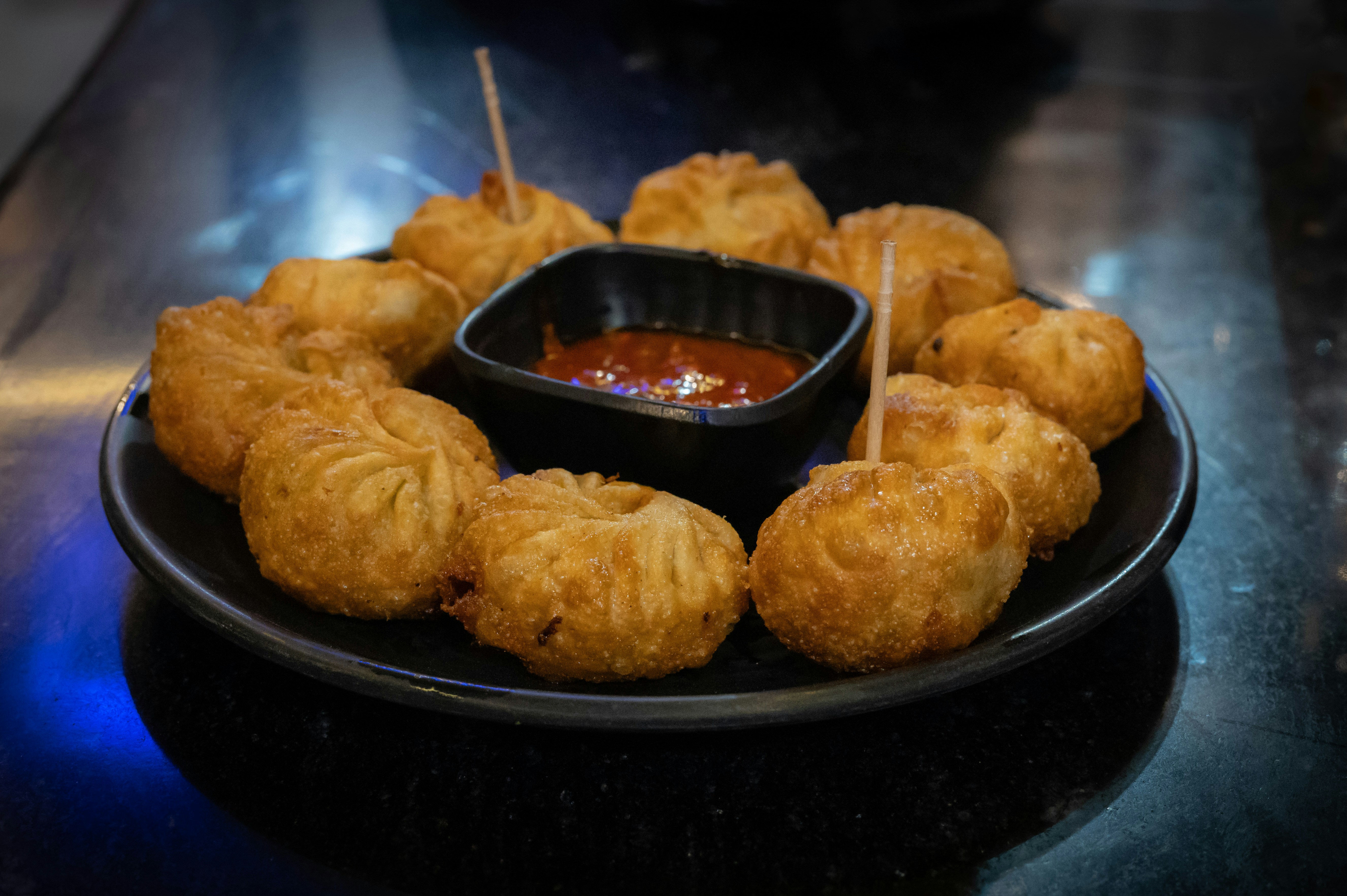 A plate of food with dipping sauce on it